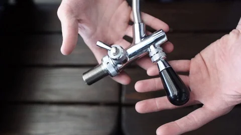 Man shows a valve for a beer machine. Beer production. 動画素材 73035900