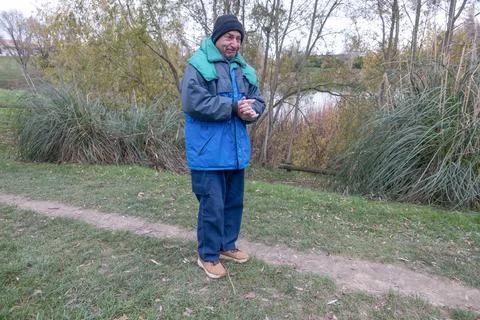 A man shrank from the cold while jogging. Stock Photos
