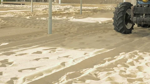 A man is sieving sand in a tractor on a beach Stock Footage 65733047