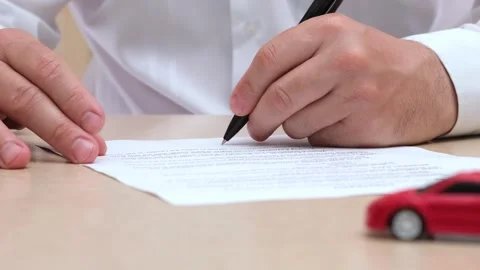 Man signing car insurance document or lease paper. Person buying new or used car Stock-Footage 274201370