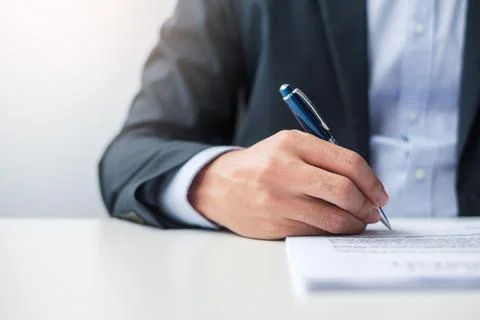 Man signing on contract documents after reading, man holding pen and approve  Stock Photos