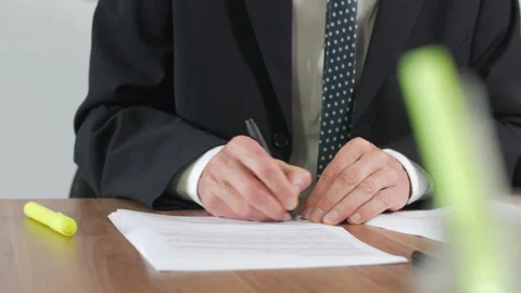 A man is signing contracts at a table Vídeo Stock 141481497