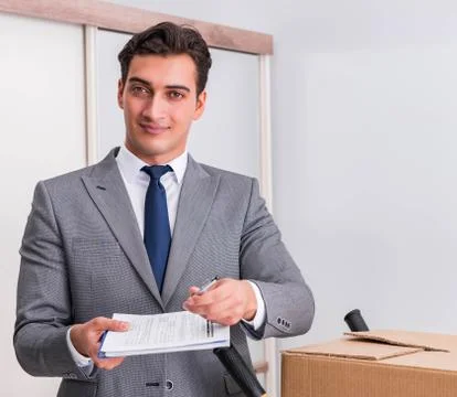 Man signing for the delivery of boxes Stock Photos