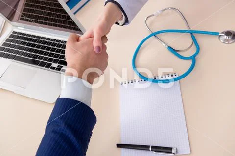 Man signing medical insurance contract Stock Photos