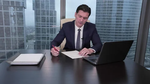 The man signs the document and window with rain drops behind him Stock Footage 64073515