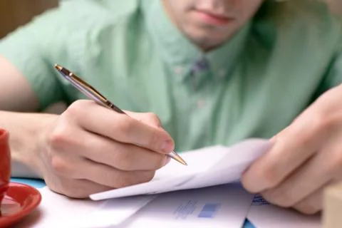 A man signs the papers. Mail Stock Photos