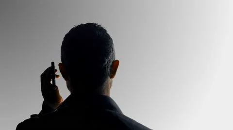 Man silhouette calling at the phone 4k Stock Footage