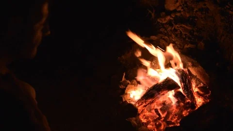 Man silhouette close to campfire at night Stock Footage 77882732
