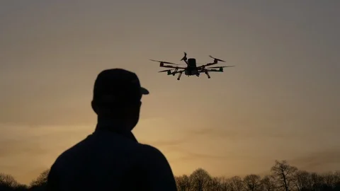 Man silhouette drone control at sunset Stock Footage 88620501