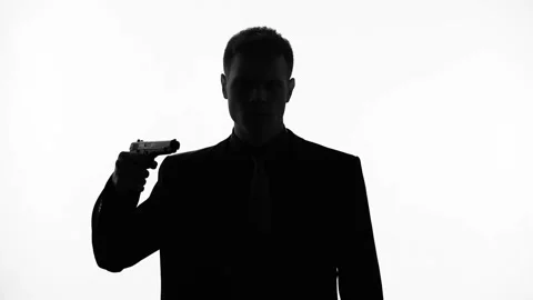 Man silhouette feel uncertain about committing suicide, pointing gun at his head 스톡 동영상 85871900