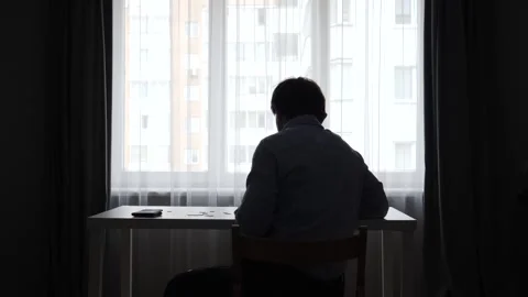 Man in silhouette holding an empty wallet, symbolizing financial crisis, debt Stock Footage 346251098