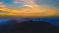 The man silhouette on a mountain against the beautiful sunset 4k or 4k+ Resolution
