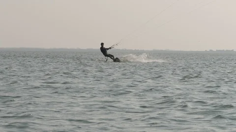 Man silhouette moves forward camera on kitesurf slow motion Stock Footage 118991827