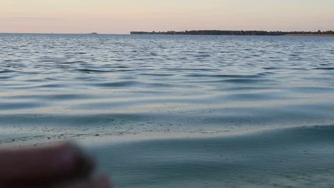 Man silhouette skipping stone on river Stock Footage 70029632