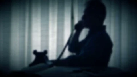 Man in silhouette talking on phone out of focus Stock Footage 82805346