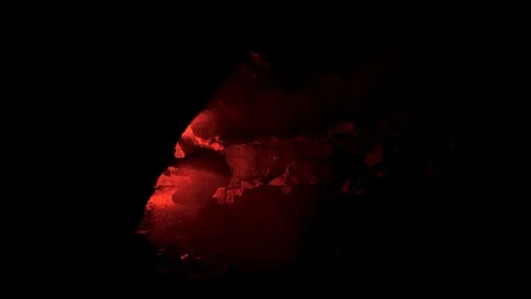 Man silhouette in an underground abandoned crypt with burning red signal flare Stock Footage 122151854