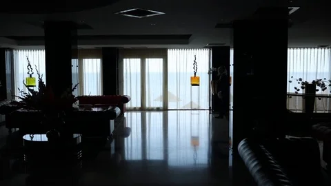 Man silhouette walks and stands against large window light 動画素材 113078853