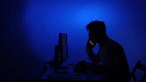 Man silhouette working computer and talking on phone Stock Footage 318982239