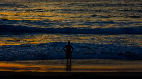 Man silhouetted at beach sunset Stock Footage 60713415