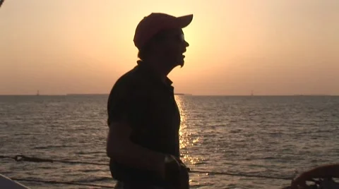 Man Silhouetted by the Sun going Down Stock Footage 5336066