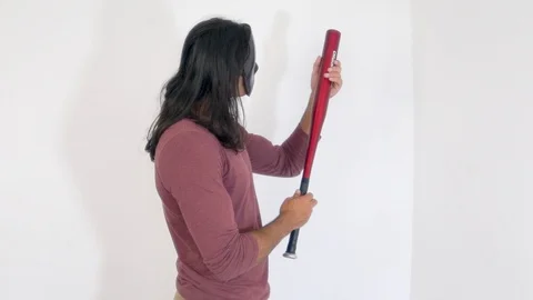 A man in a silver mask with a baseball bat, on a white background Video stock 120463464