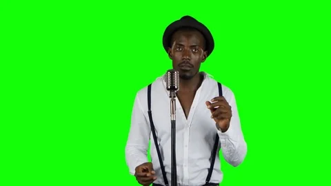 Man singer sings into a microphone and dance. Green screen Stock Footage 79343513