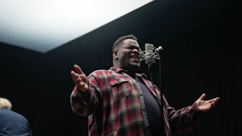 A Man Singing Intensely Into A Microphone Stock Footage 236512685