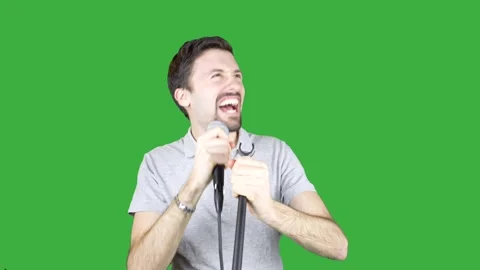 Man Singing Into Microphone on Green Screen Video stock 237243152