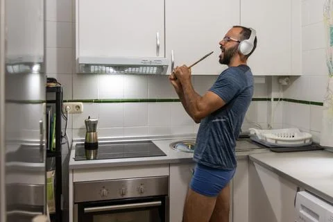 Man singing while doing the dishes Stock Photos
