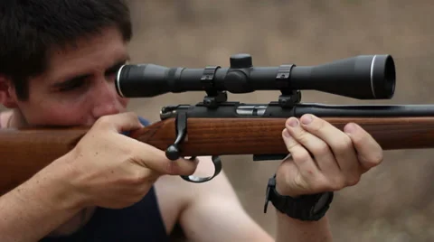 Man in singlet shooting rifle Stock Footage 39077306