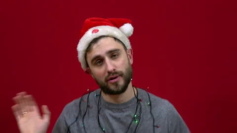 The man sings and dances with a dancing live Christmas hat on his head. Santa's Stock Footage 144639602