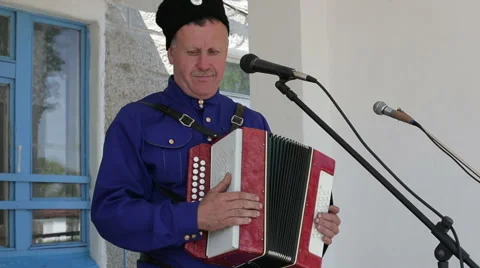 Man sings into a microphone and playing the accordion, Russian folk  Stock Footage 63750941