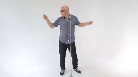 Man sings a song charismatically dancing jumping with the microphone Stock Footage 82188874