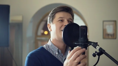 A man sings into a studio microphone Stock Footage 87351699