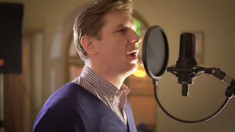 A man sings into a studio microphone Video stock 87351908