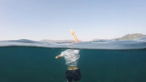 Man sinking into the sea Stock Footage 77665691