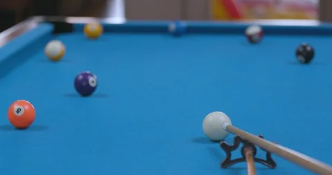 Man Sinking Shot in Corner Pocket on Blue Billiards Table with Bridge Stock Footage 88227314