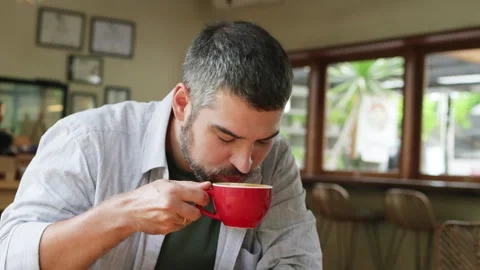 Man sipping coffee from red cup. Stock Footage 272585935