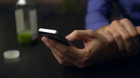Man sips healthy juice while using device Stock Footage 85447137