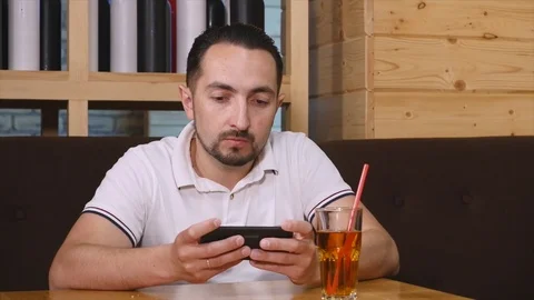 Man sit and use smartphone in the cafe Stock Footage 76735176