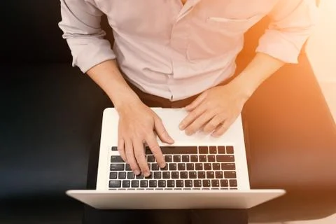 A man sit and using notebook Stock Photos