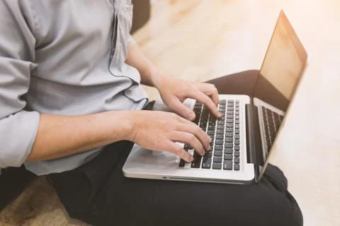 A man sit and using notebook Stock Photos