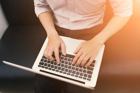 A man sit and using notebook Stock Photos