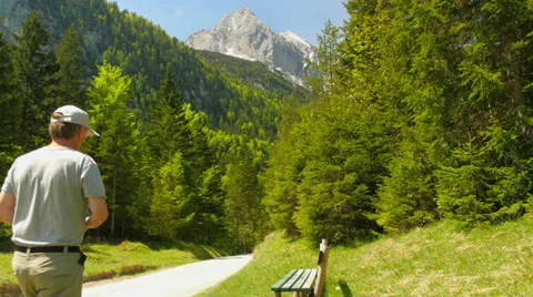 Man sit on bench to relax. Bavaria Alps Stock Footage 39137802