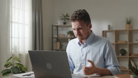 Man sit at desk stressing out while work on laptop Stock Footage 213901024