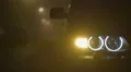 The man sit down and get out of the car. Evening-night time, foggy weather 4k or 4k+ Resolution