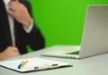 The man sit near the laptop on the green background Photo