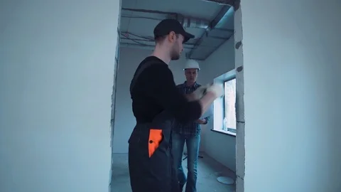 Man on a site with blueprint Stock Footage 74674809