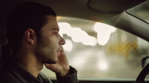 A man siting in the car and speaking on mobile phone Stock Footage 47896644