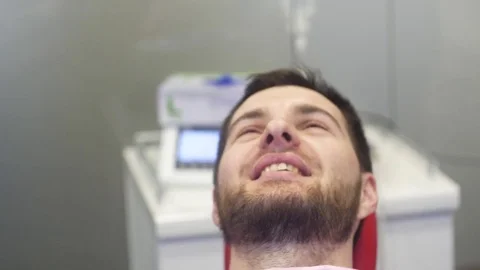 Man siting in dentist chair, pull up a tooth 動画素材 81179818
